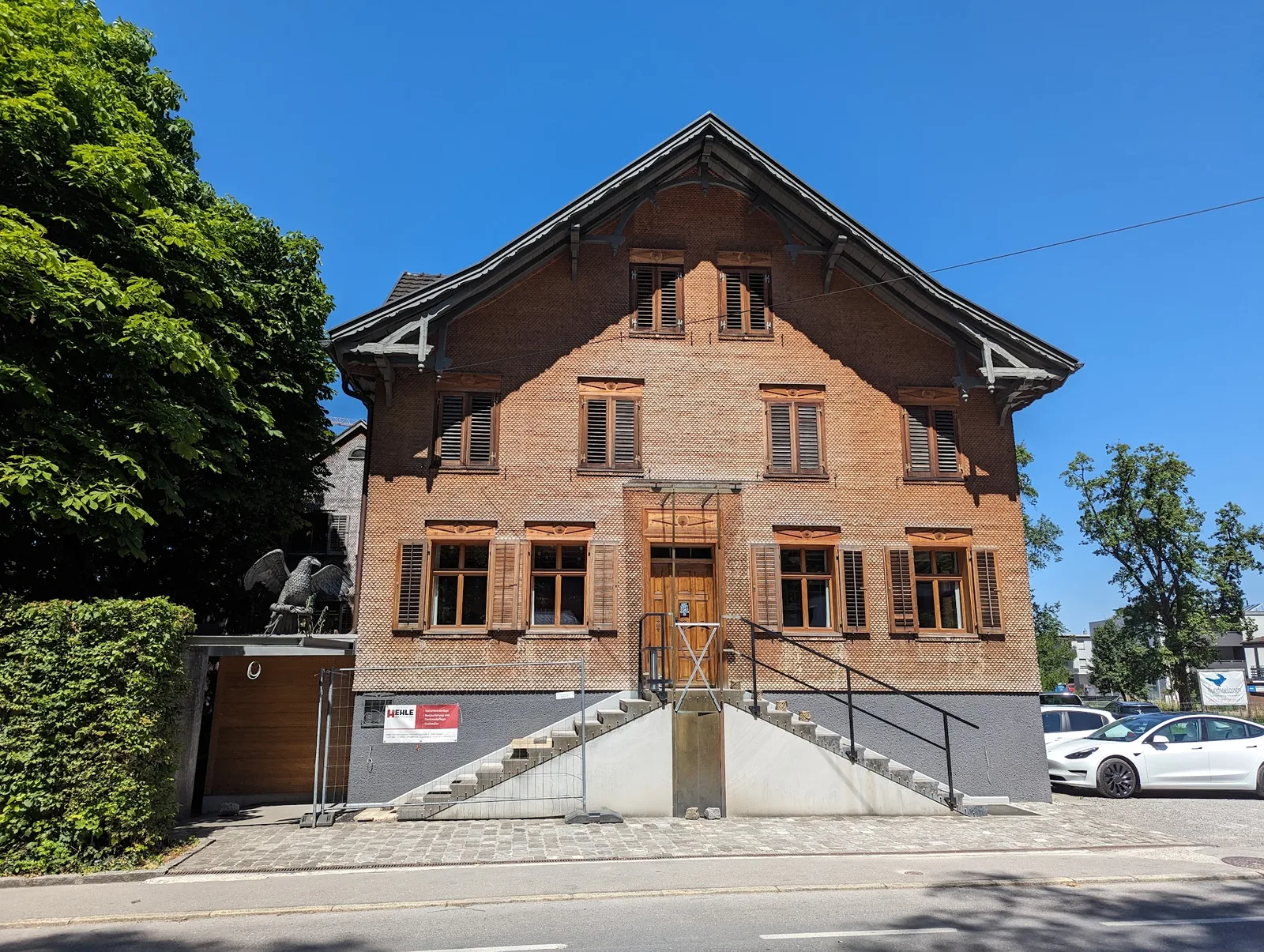 Das Gasthaus Adler von der Kaiser-Franz-Josef-Straße aus, Schindelfassade mit Holzläden und Treppe zum Eingang
